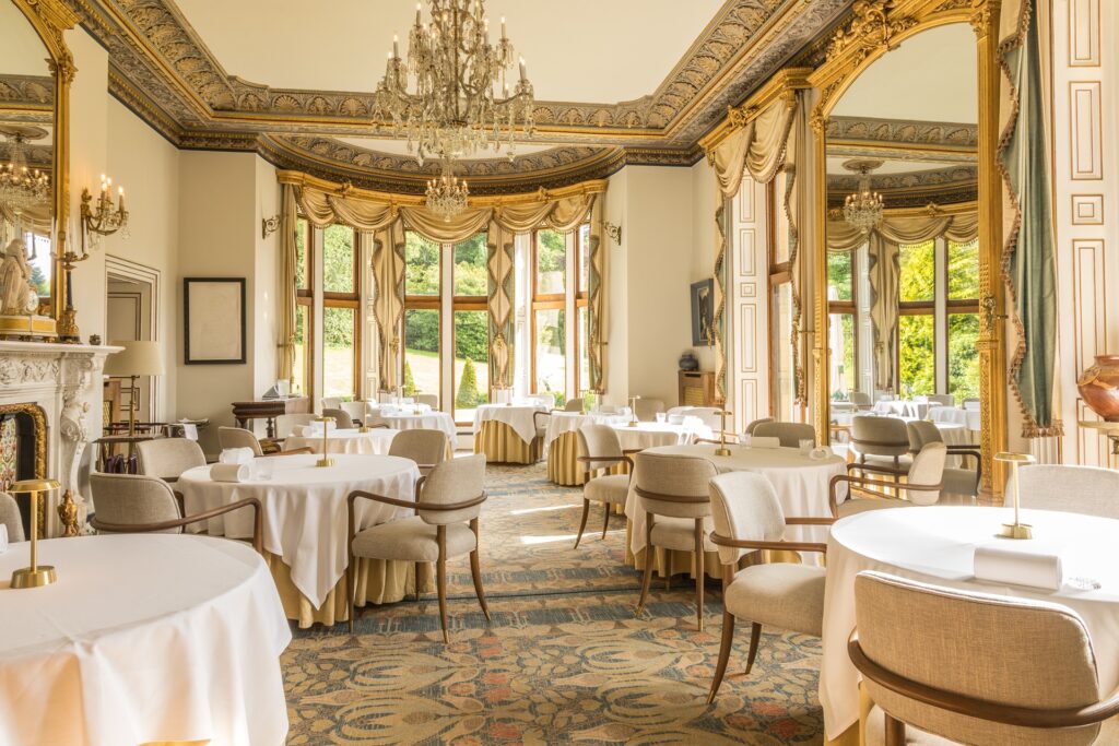 Interior dining room at Palé Hall with tables laid for dinner