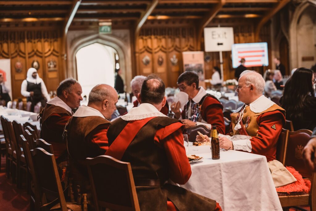 Beefeaters sitting donw and enjoying a meal at the Lord Mayor's Big Curry Lunch in Guildhall