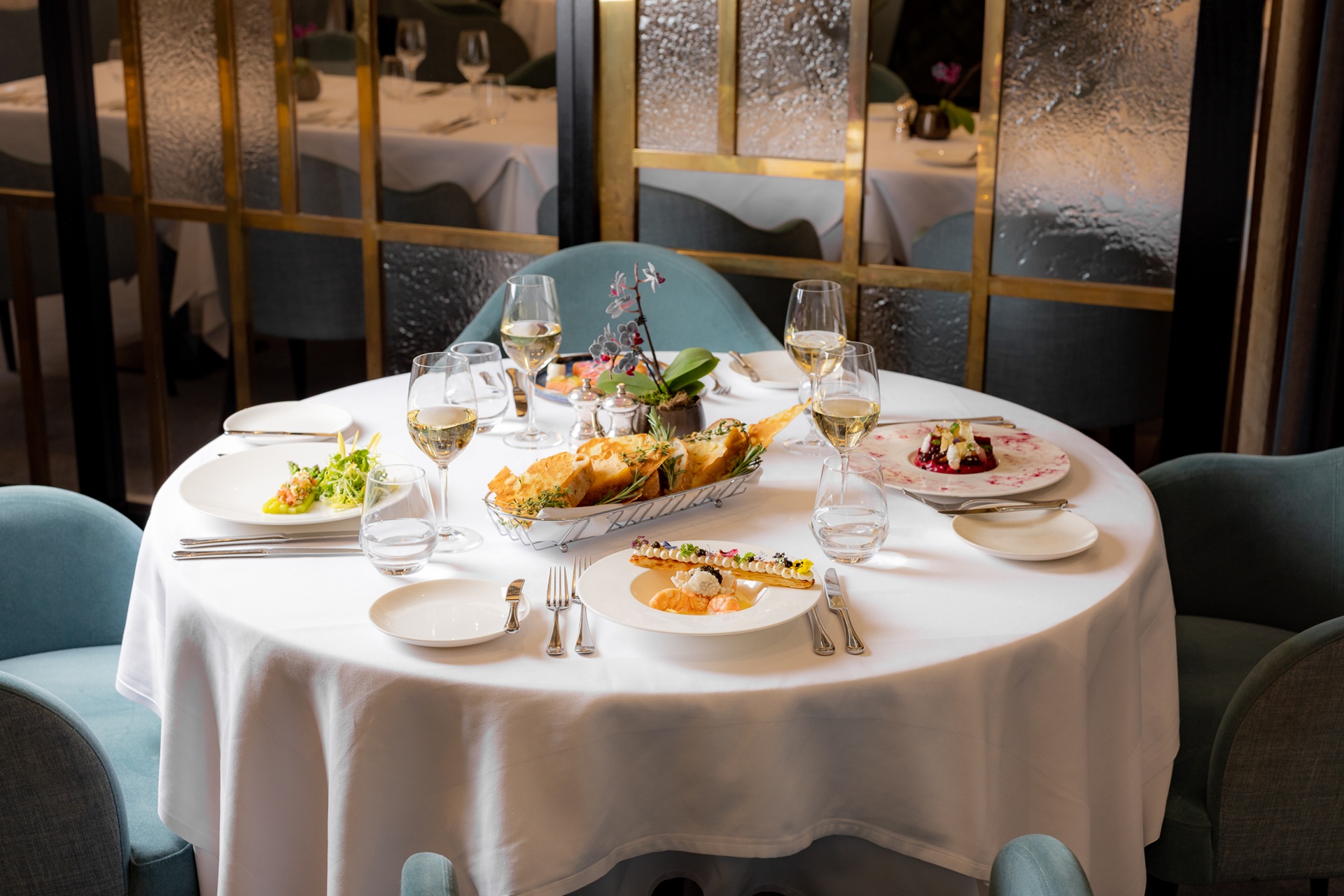 A set table in The Lansdowne Club Dining Room with multiple dishes served.