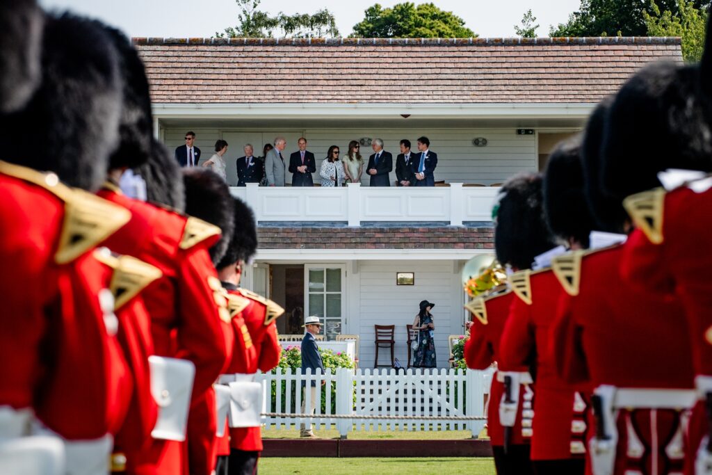 Pageantry and Coldstream Guards outside the Royal Box at Guards Polo Club