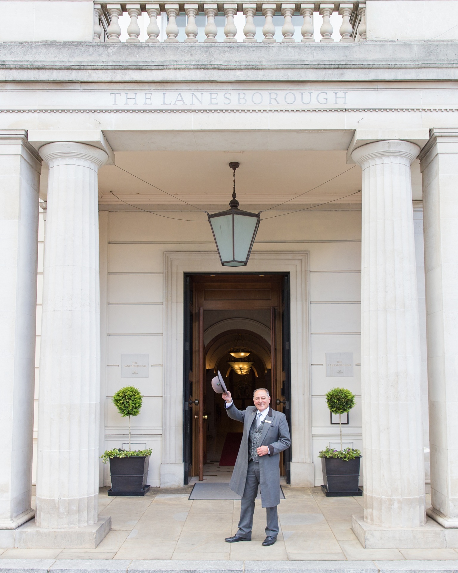 Doorman outside The Lanesborough Hotel welcoming guests